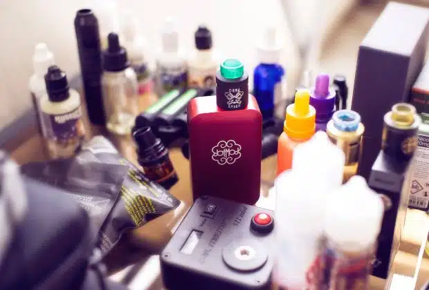 red box mod vape beside e-juice bottles